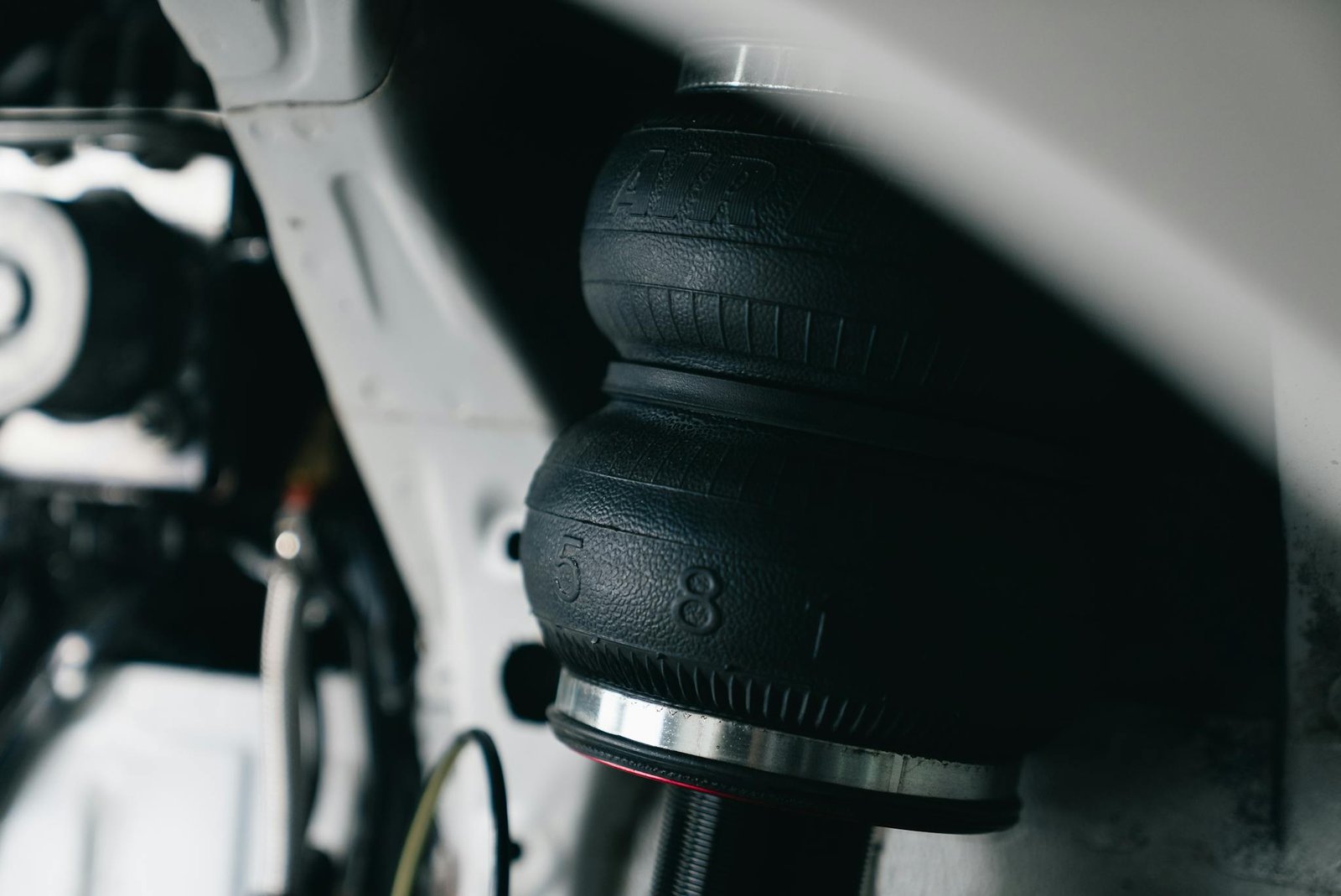 Detailed view of a vehicle's air suspension component with focus on texture and design.